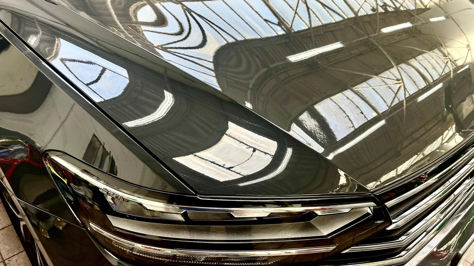 Close-up of glossy detailed paintwork and headlight