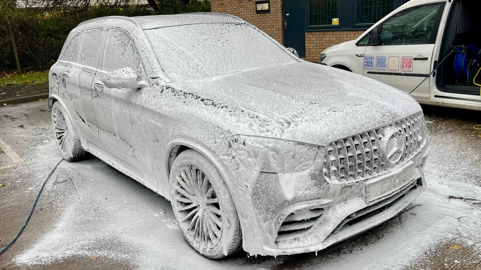 Mercedes covered in snow foam during wash